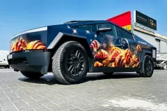 Printzone Advertising LLC vehicle branding company in Dubai Al Quoz wrapping a commercial car with full vinyl wrap