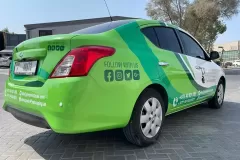 Printzone Advertising LLC vehicle branding company in Dubai Al Quoz wrapping a commercial car with full vinyl wrap
